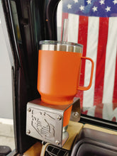 Cargar imagen en el visor de la galería, Orange yeti cup  inside metal cup holder that has USMC logo mounted on drivers side of TJ Jeep Wrangler