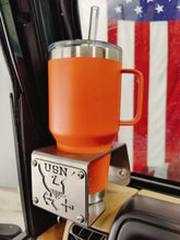 Cargar imagen en el visor de la galería, Orange yeti tumbler inside metal cup holder with USN logo mounted on drivers side of Jeep Wrangler TJ with American flag in background