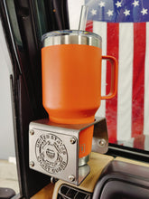Cargar imagen en el visor de la galería, Orange yeti cup  inside metal cup holder that has USCG logo mounted on drivers side of TJ Jeep